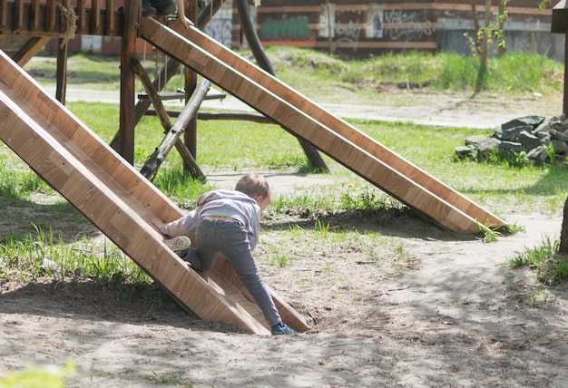 Little boy in the playground in the summer