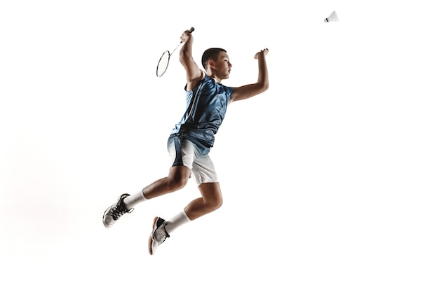 Little boy playing badminton isolated on white studio background