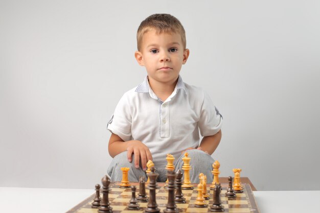 Little boy playing chess