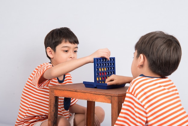 Little boy playing connect four game soft focus at eye contact