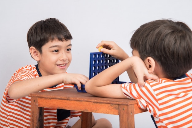 Little boy playing connect four game soft focus at eye contact