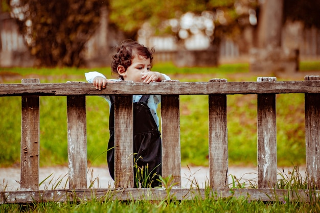 Little boy playing on the grass in a park