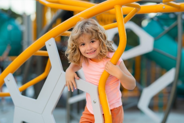 Little boy playing on the playground the emotion of happiness fun joy smile of a child