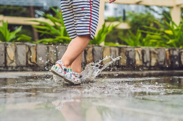 水たまりで遊ぶ少年