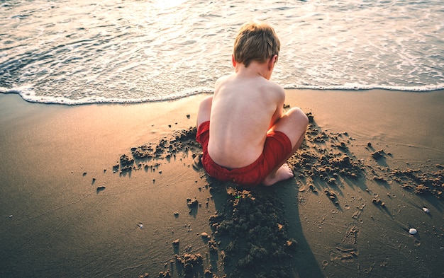 A little boy playing in the sand