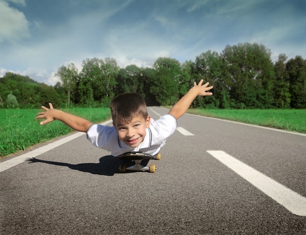 Little boy playing on a skateboard