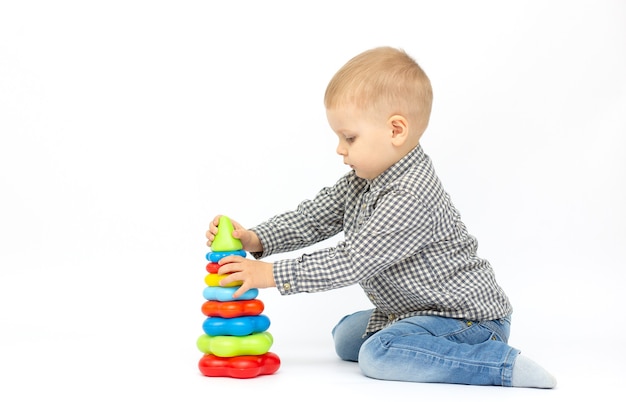 Little boy playing toy isolated on white background