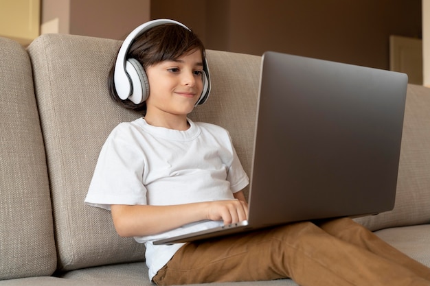 Little boy playing a video game on his laptop