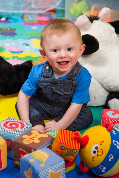 Little boy playing with colored soft cube