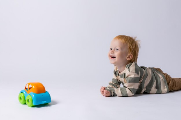 little boy playing with a typewriter on a white background