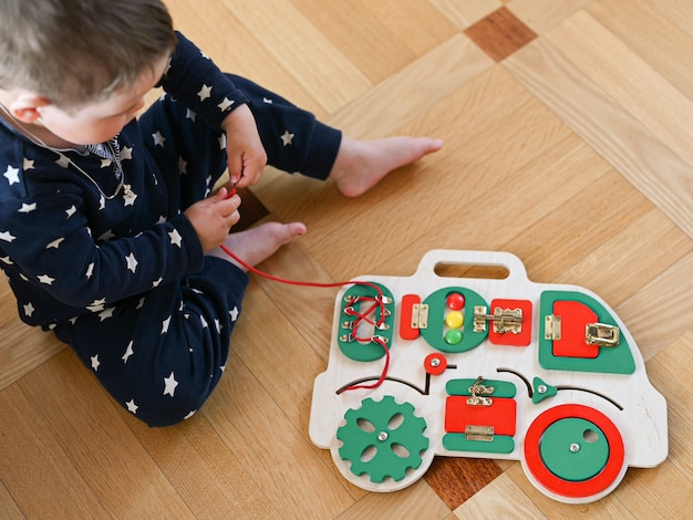 little boy plays with a developmental toy