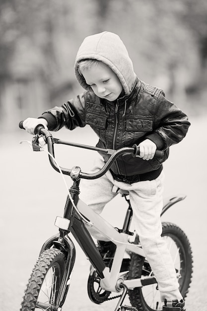 Little boy riding a bike outdoors