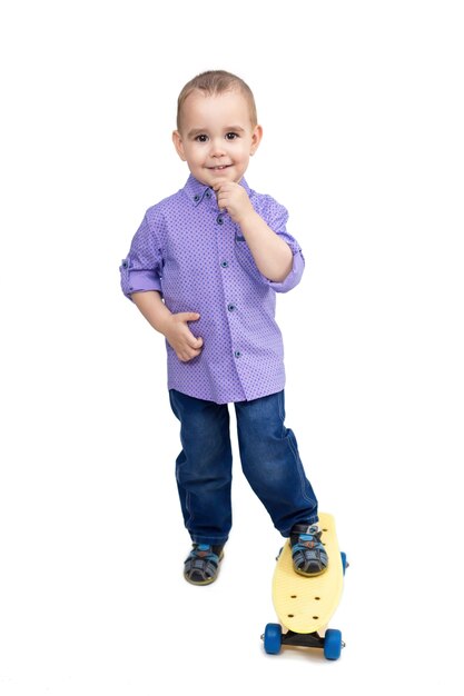 Little boy riding a skateboard isolated White background.