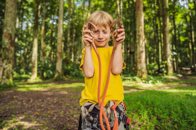 Little boy in a rope park Active physical recreation of the child in the fresh air in the park Training for children