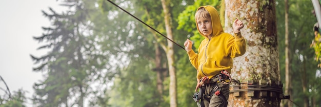 Little boy in a rope park active physical recreation of the child in the fresh air in the park