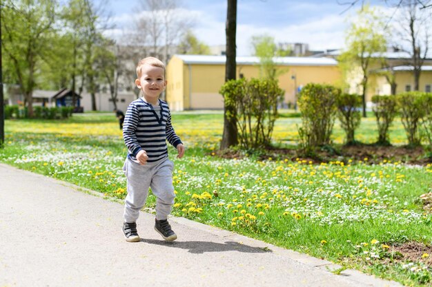 Little Boy Runs in a Summer Park