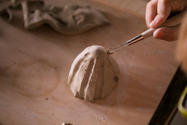 Little boy sculpts from clay with interest