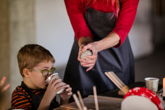 Little boy sculpts from clay with interest