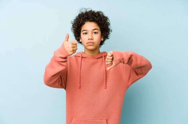 Little boy showing thumbs up and thumbs down