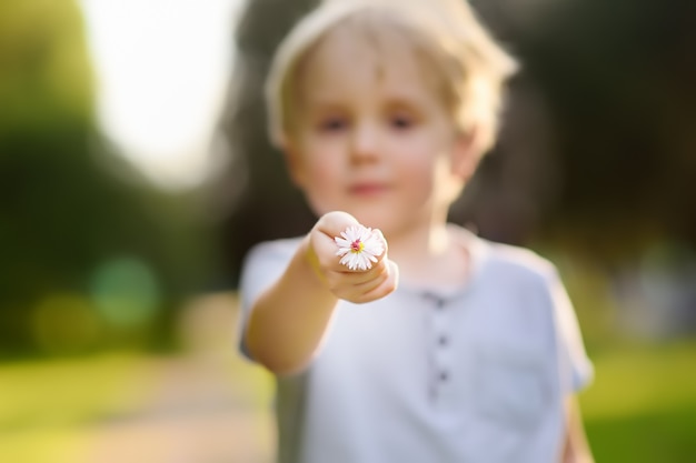 Little boy shows flower and asks a question what is