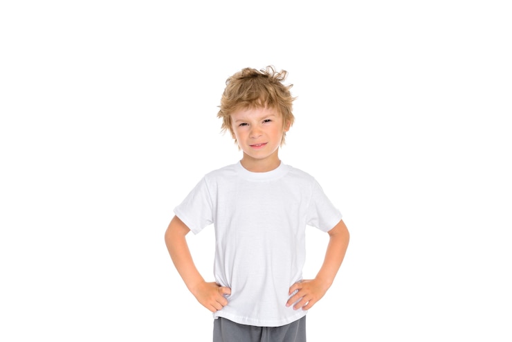 Photo little boy shows his displeasure with his facial expression and holding his hands at his waist.