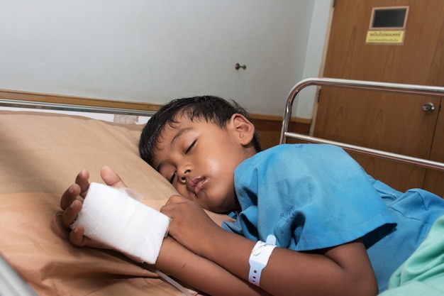 Little boy sick in the hospital with saline intravenous