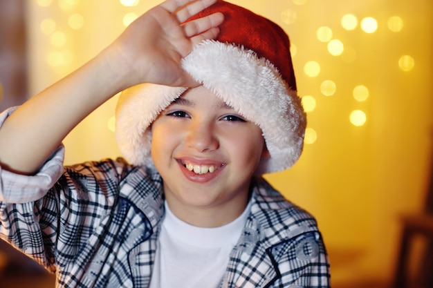 Little boy sitting near fireplace in room