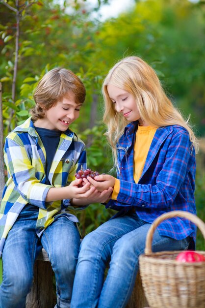 Little boy smiling and girl in the autumn park