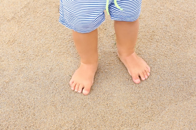 Little boy standing on beach