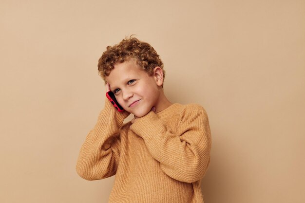 Little boy in a sweater talking on the phone