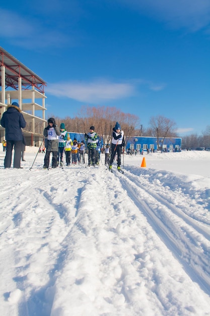 little boy a teenager runs through the snow on skis Cross country skiing competitions