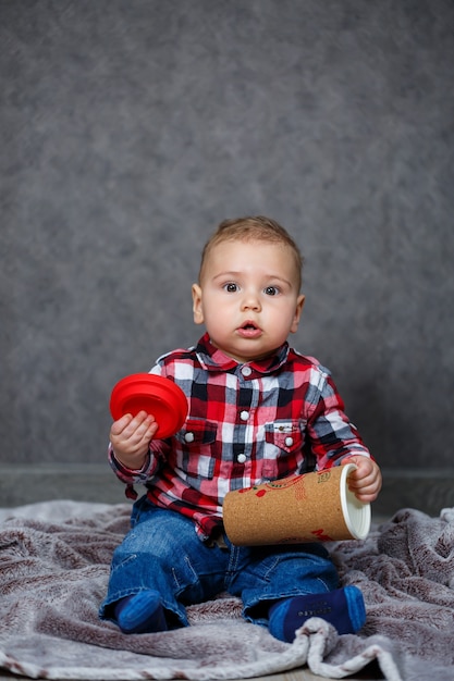 Little boy ten months old in a shirt and jeans