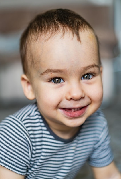 A little boy that is smiling for the camera