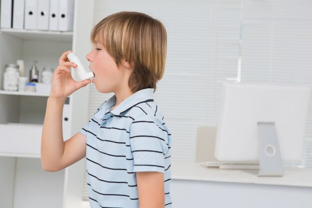 A little boy using inhaler 