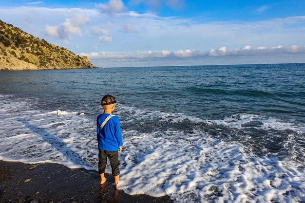 A little boy in Veselovskaya Bay Crimean Riviera near Sudak Crimea Russia 2021