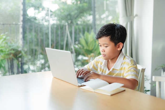 Little boy in virtual class school at home