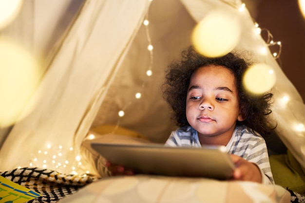 Little boy watching cartoon on tablet pc