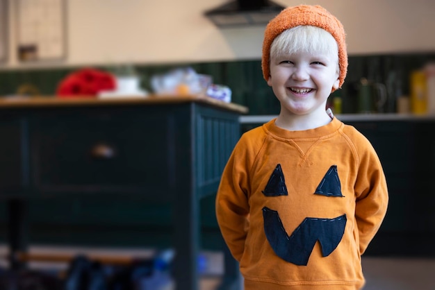 A little boy wearing a homemade pumpkin halloween costume