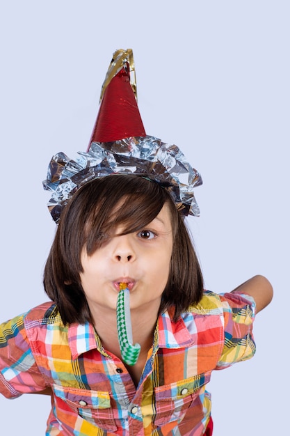 Little boy wearing a party hat.