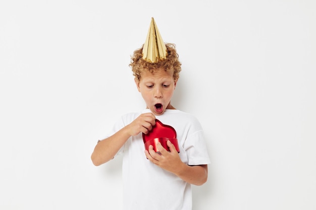 Little boy wearing a white tshirt with a cap on his head birthday gift