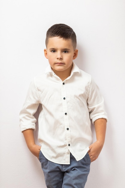 Premium Photo  Little boy in a white shirt in the studio