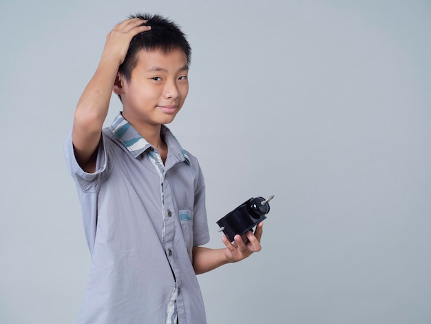 Little boy with alarm clock