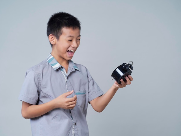 Little boy with alarm clock