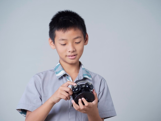 Little boy with alarm clock