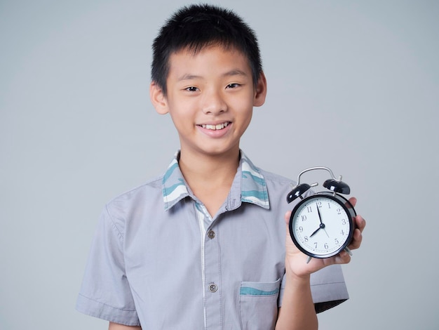 Little boy with alarm clock