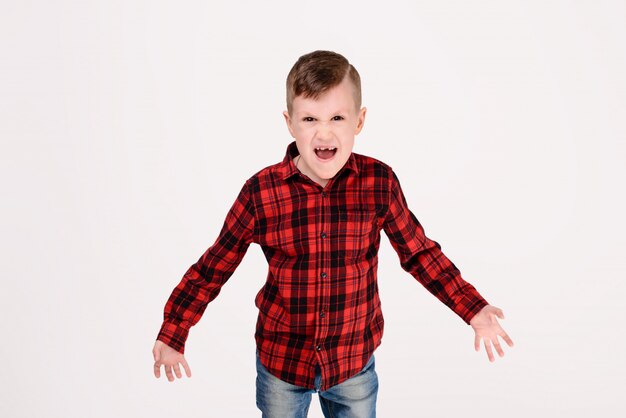 The little boy with expressive emotion on a white background. 