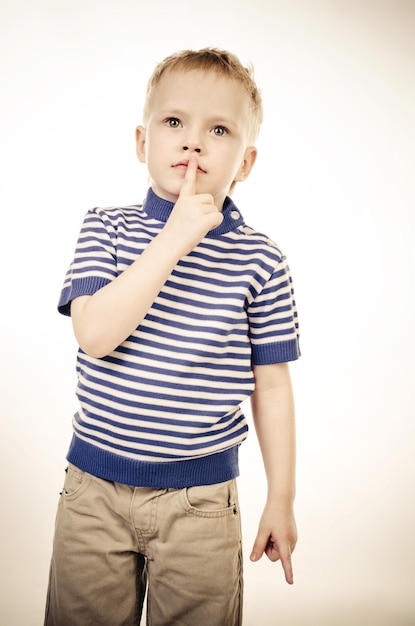 Little boy with finger on his mouth