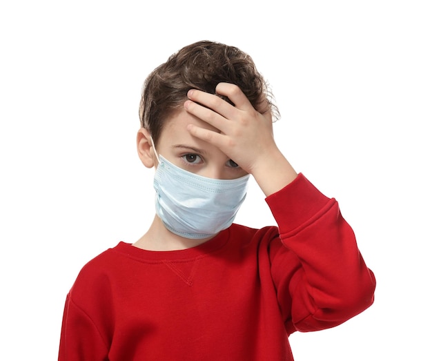 Little boy with flu in facial mask on white background