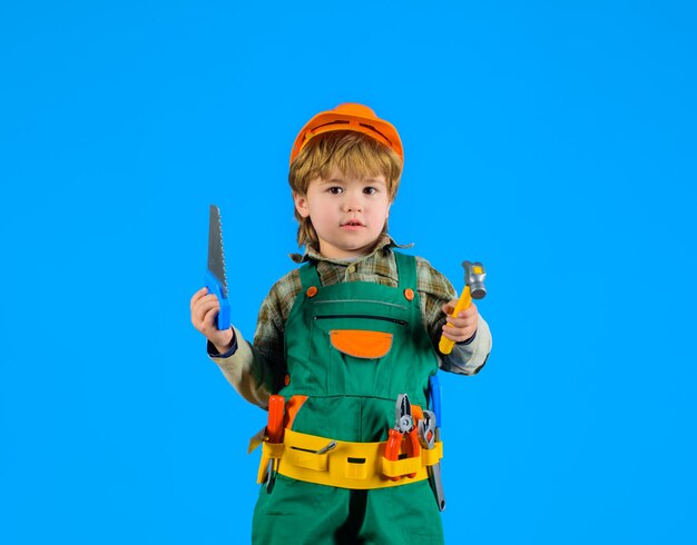 Little boy with helmet and tools little repairman kid as construction worker little boy in builders