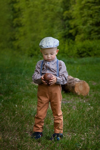 Little boy with a large chocolate egg in the nature